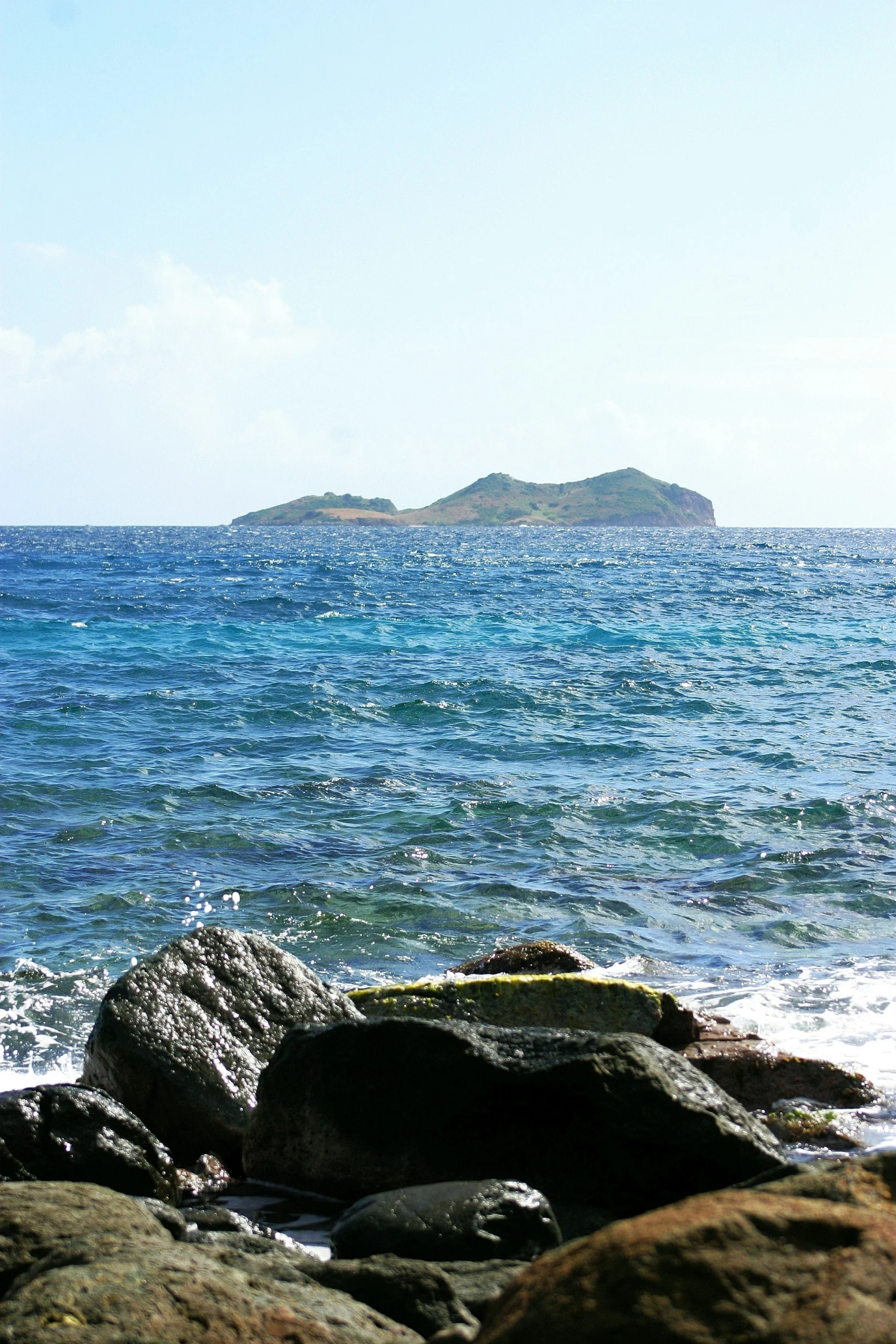 the view from a rock looking at some water