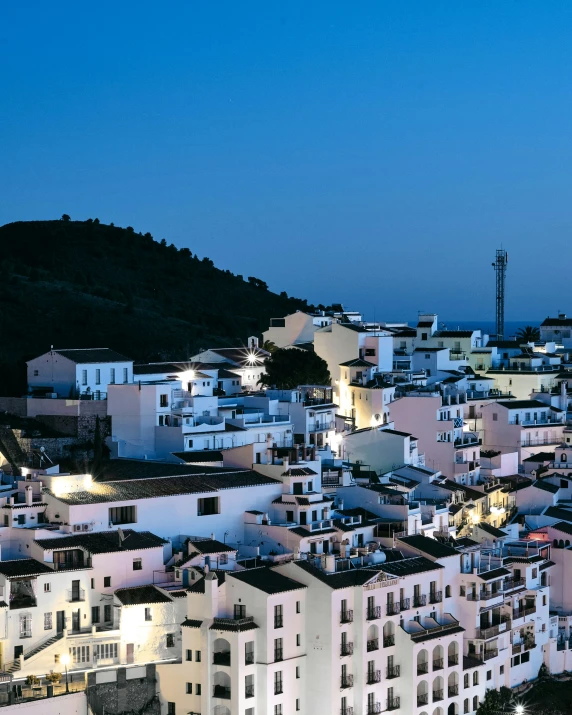 a small town at night near a hill