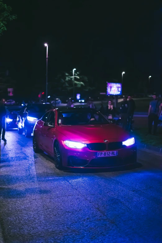 a red car is parked next to the curb