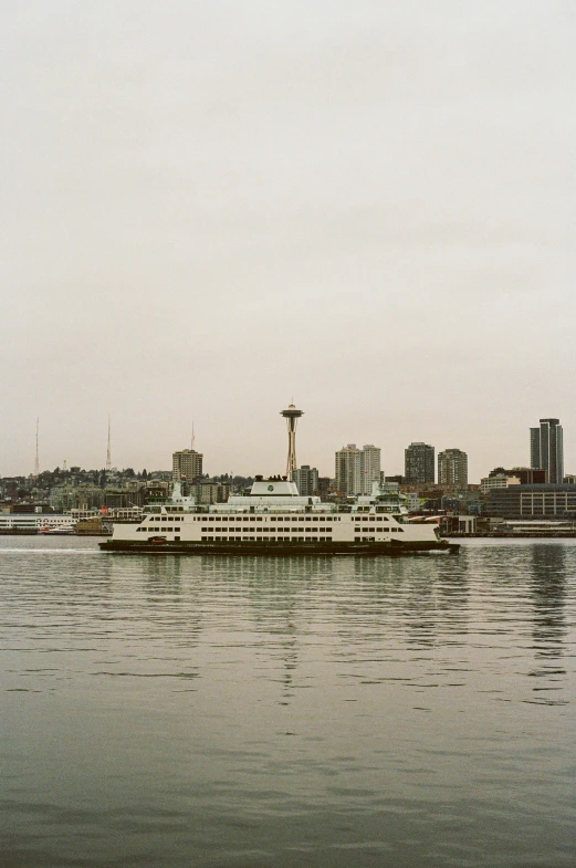 a boat on the water near a large city