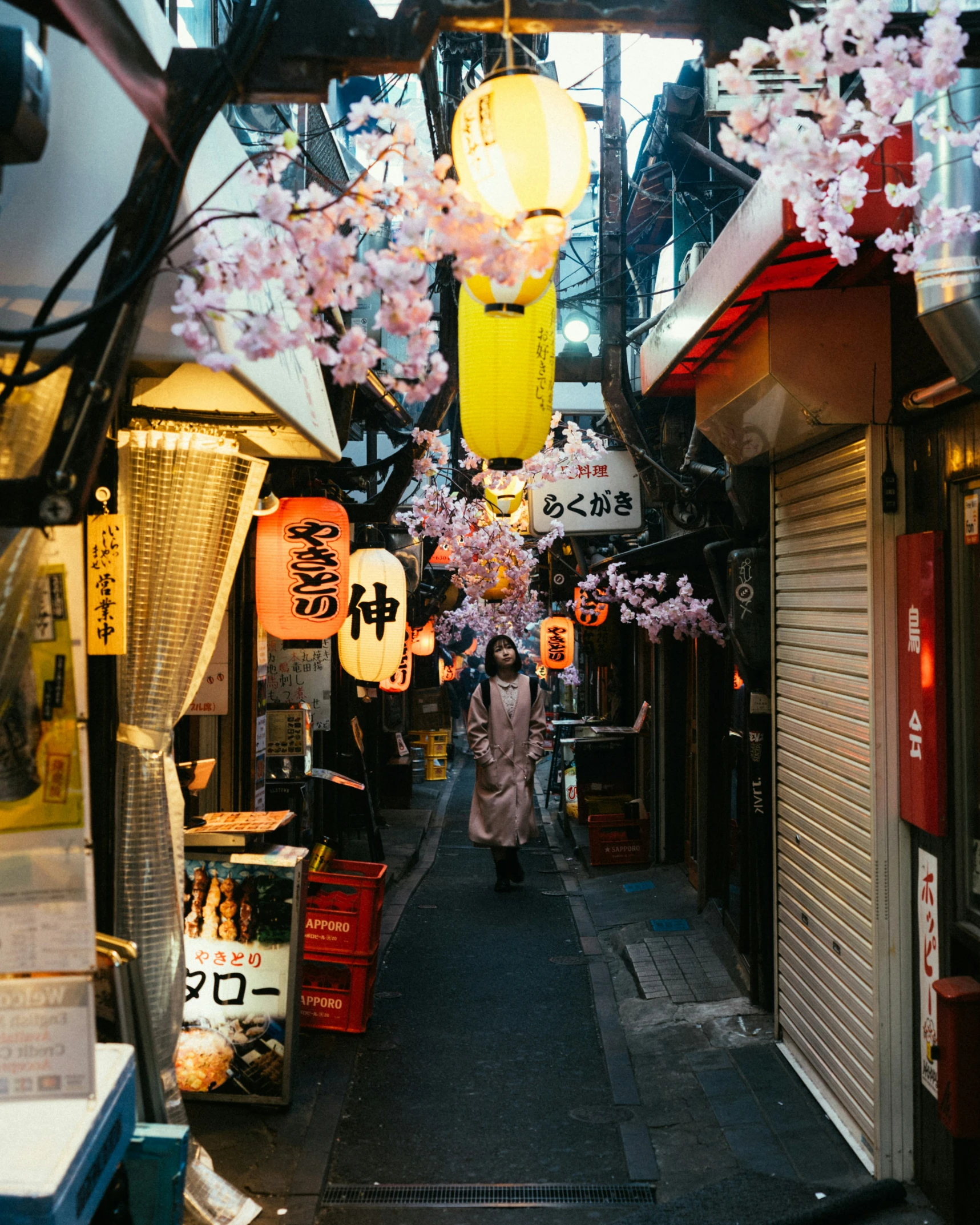 an alleyway with many signs and lights above it