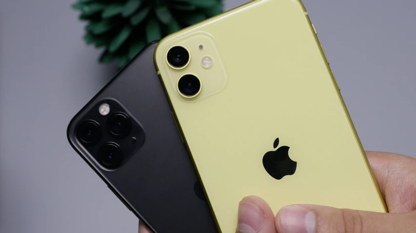 a person holding a yellow and black iphone