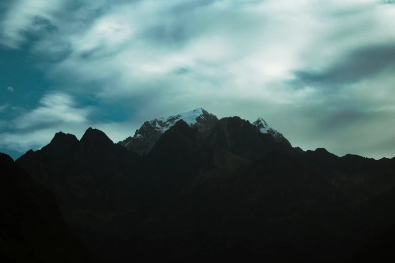 view of the mountains in the dusk, with a plane taking off from it