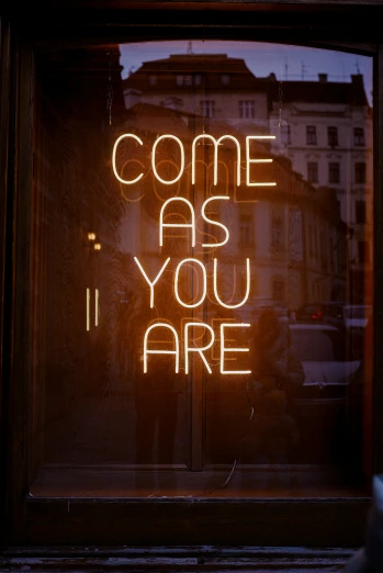the words come as you are written in neon light