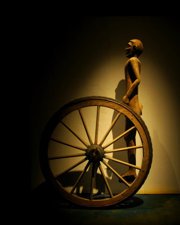 a figure that is standing near a wheel