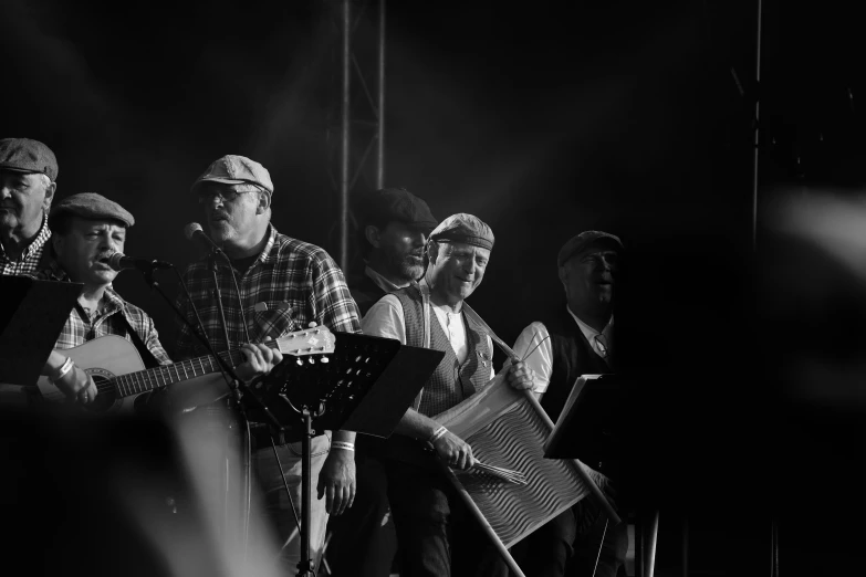 several people with instruments standing in front of a stage