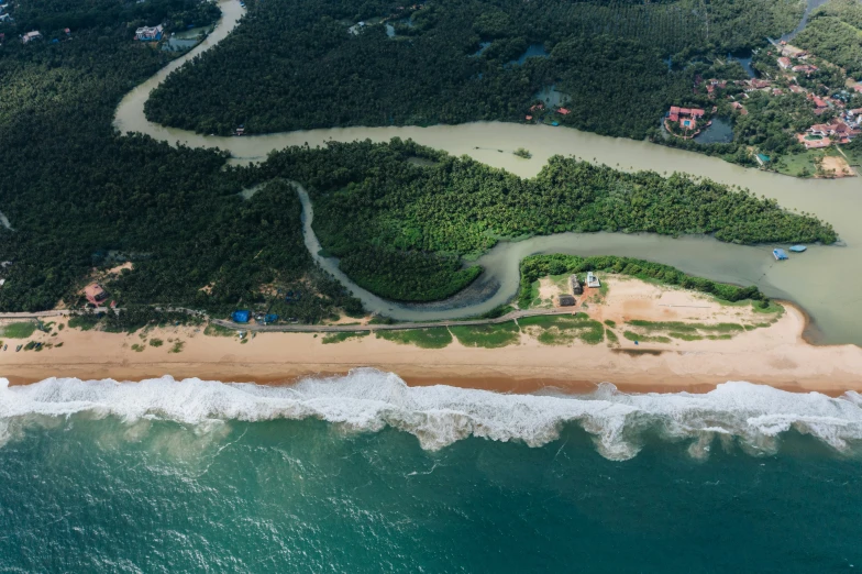 an aerial po of the beach and lagoon in a forested area