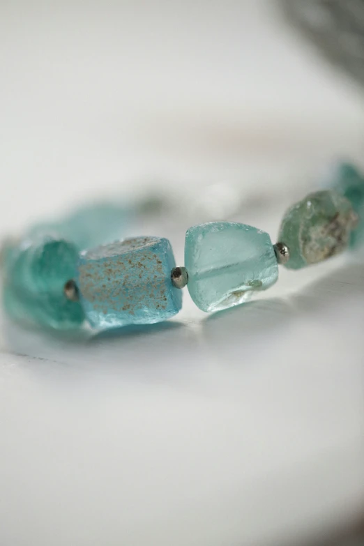 a close up po of an aqua colored celet