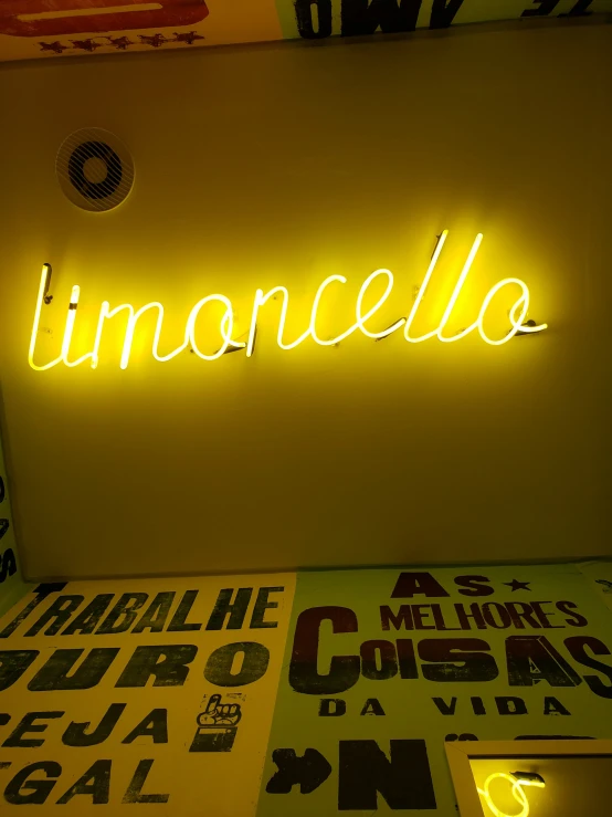 a lit up sign that says limoocallo above a table
