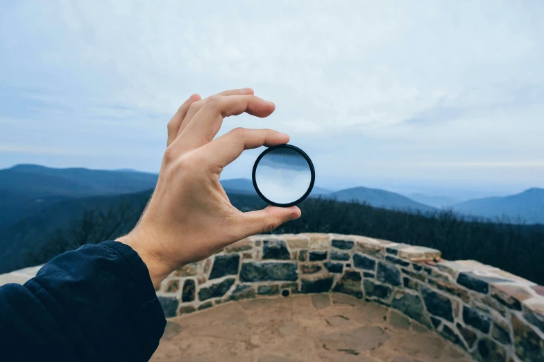 a person holds an object up to take a picture