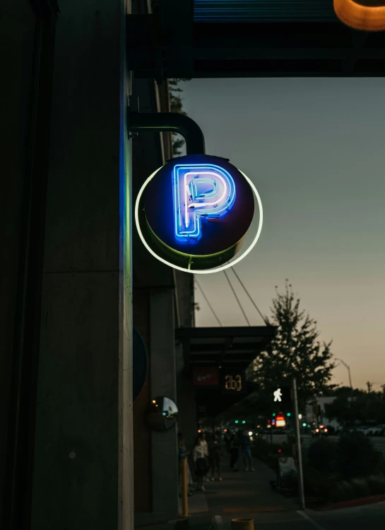 a neon sign is displayed on the side of a building