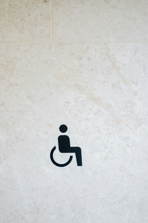 a small handicapped toilet sign with a person in it