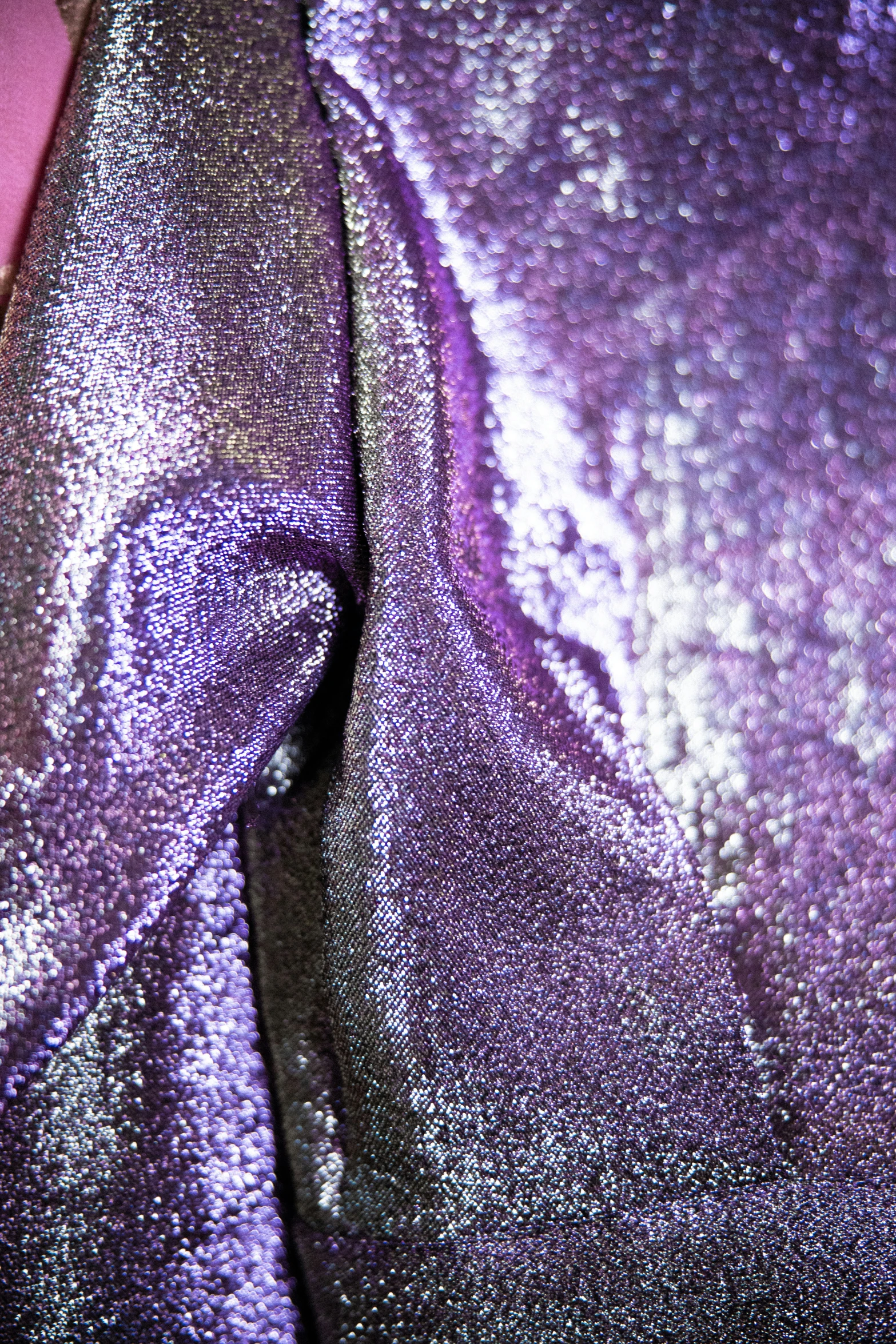 a purple colored fabric with small and dark designs