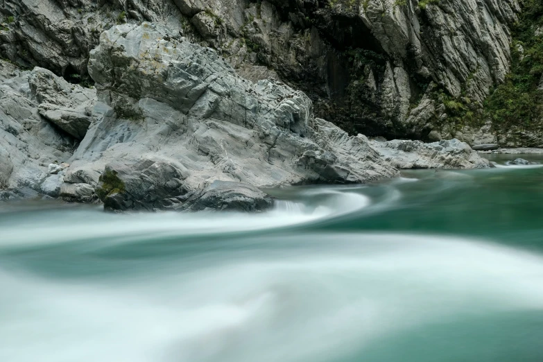 a mountain river that is blue and green