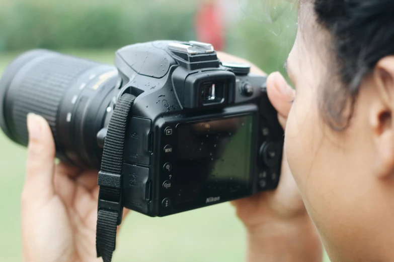 a woman with a camera up to her eye