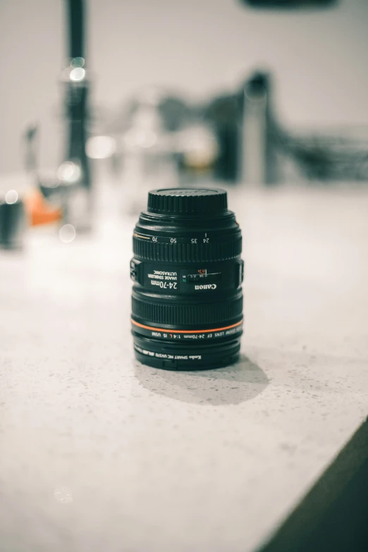 a canon camera sits on a table next to a machine