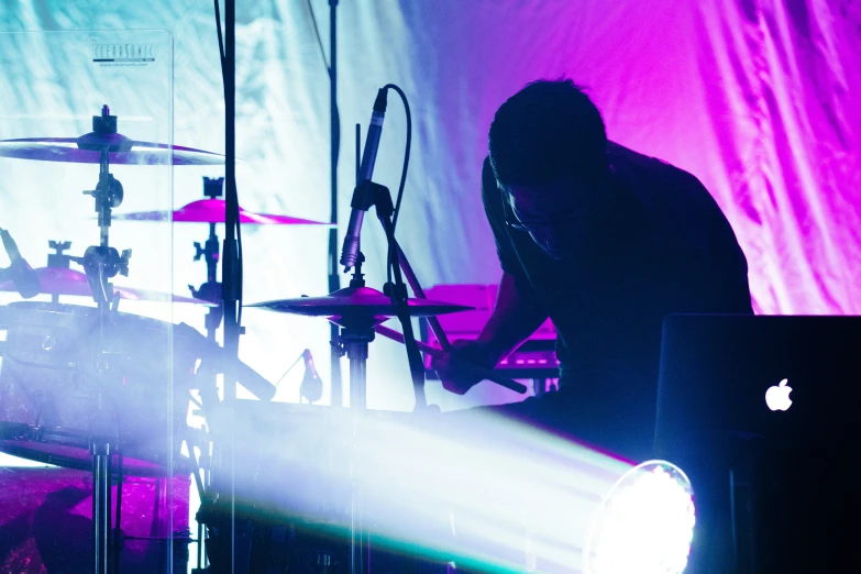 a concert scene of a band playing in front of a spotlight