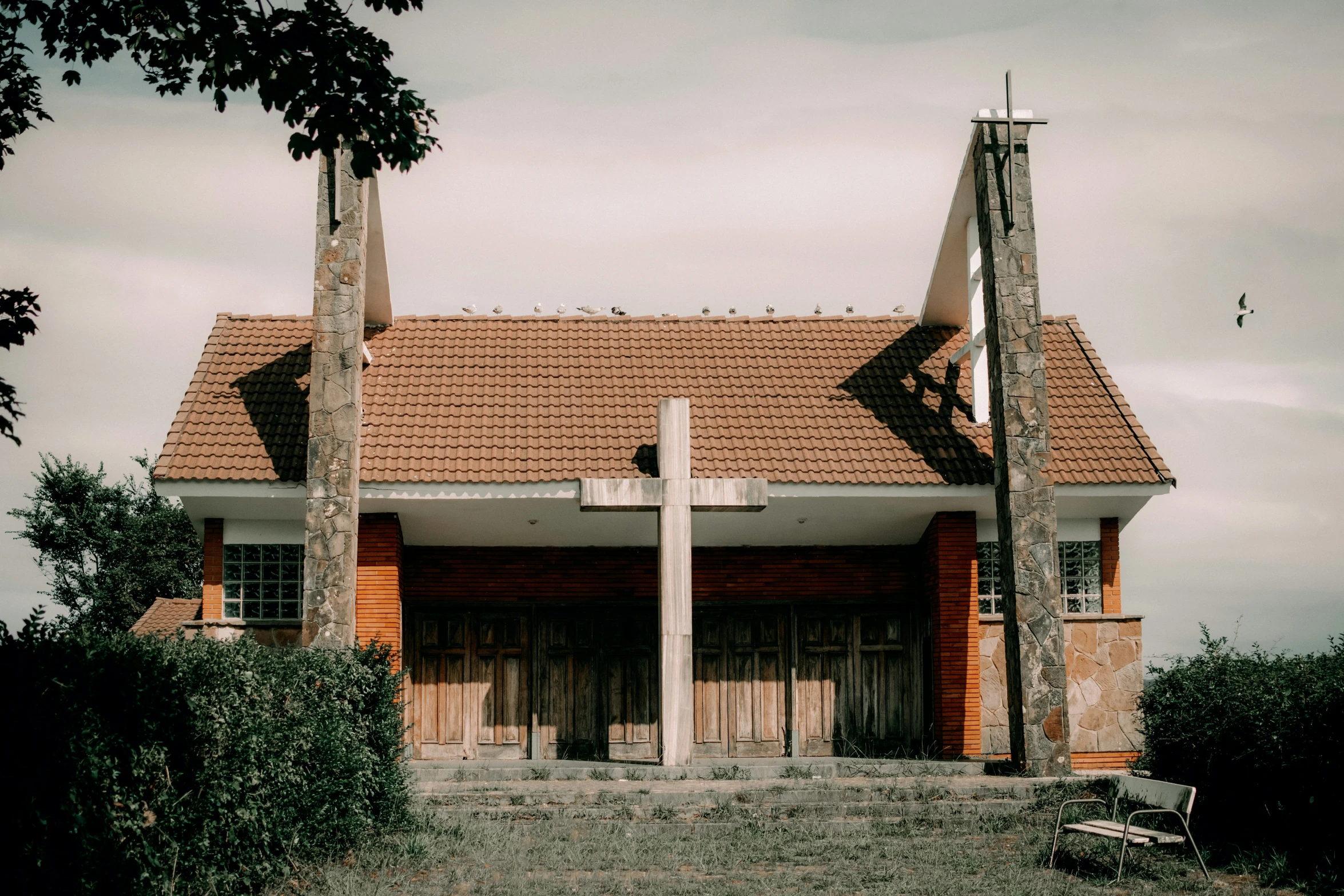 a large wooden cross on top of a brick building