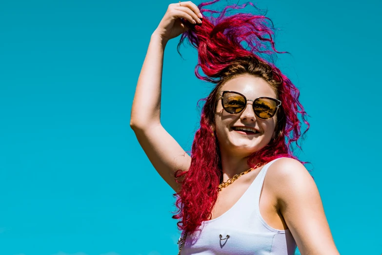 a woman wearing sunglasses and pink hair