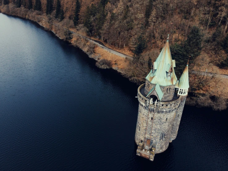 an aerial view of the castle in the middle of the lake