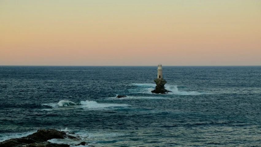 a lighthouse sitting in the middle of a body of water