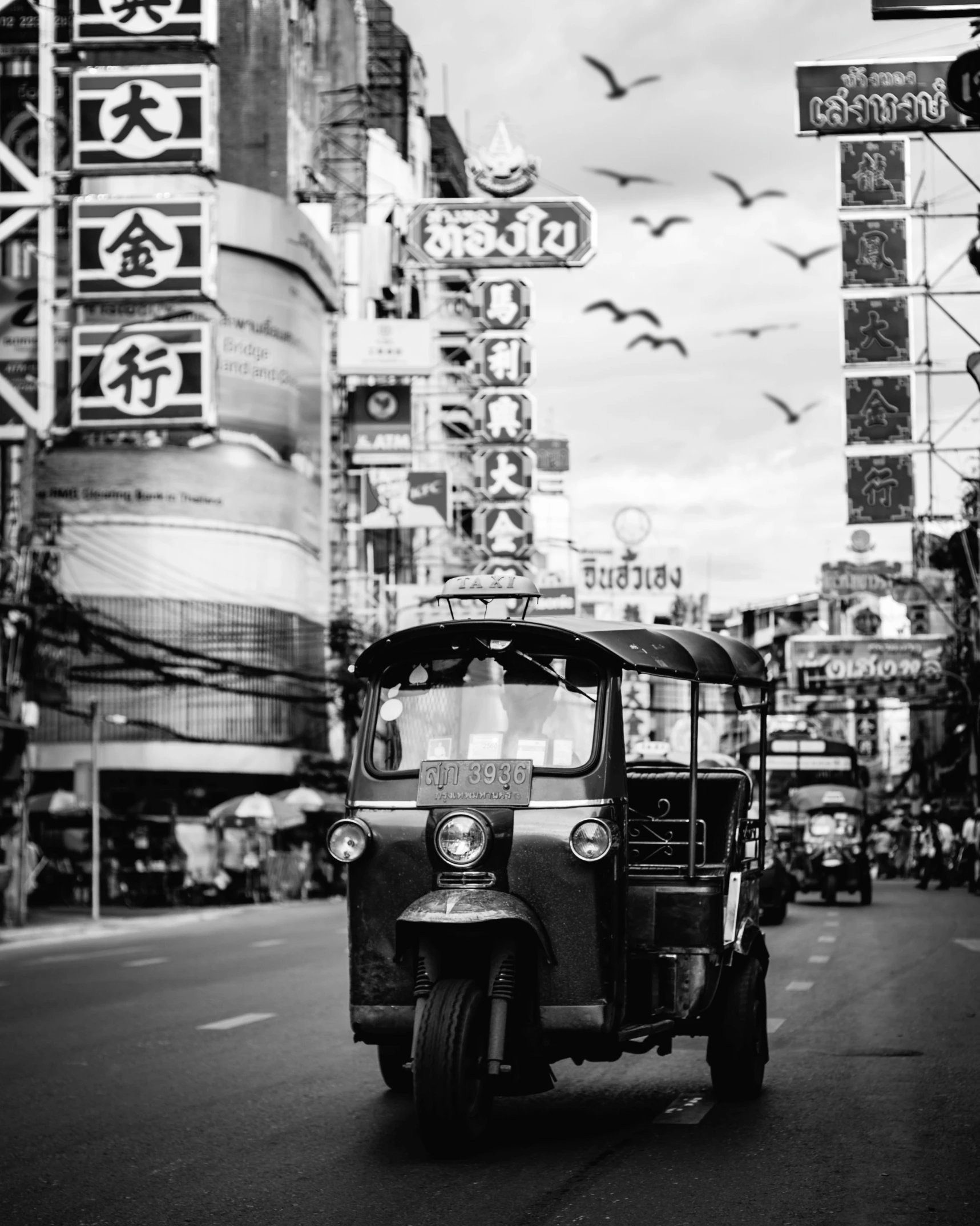 a tuk tuks in front of a street filled with traffic