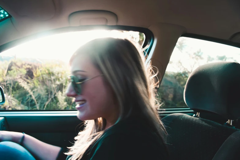 woman in back seat of car using cell phone