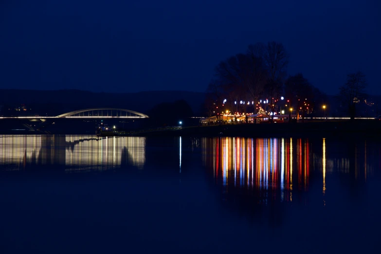 light streaks are projected across the water at night