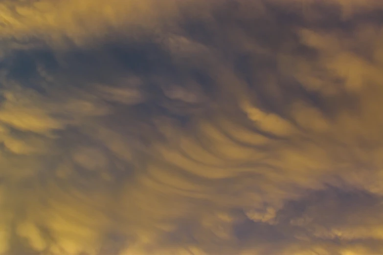 a plane flying through the air with a lot of clouds