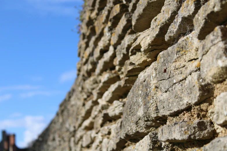 the sky is shown behind a stone wall