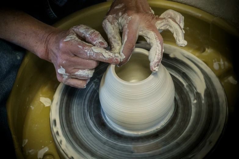a person making soing on a potter's wheel