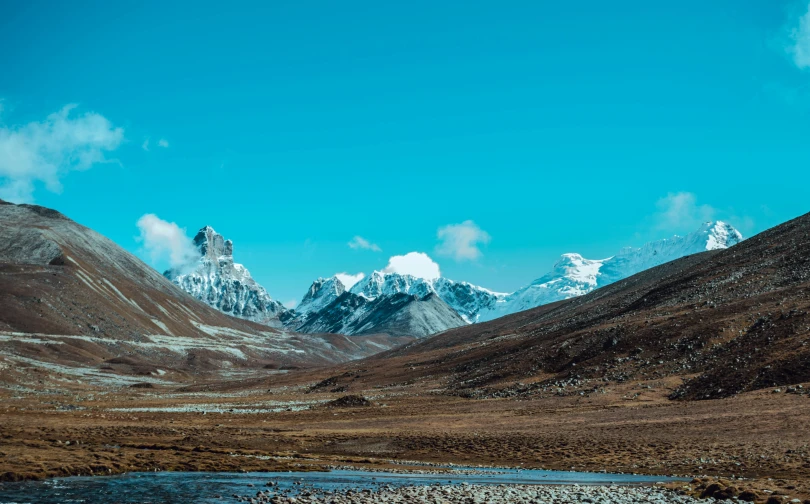 a scenic mountain scene with snow covered peaks