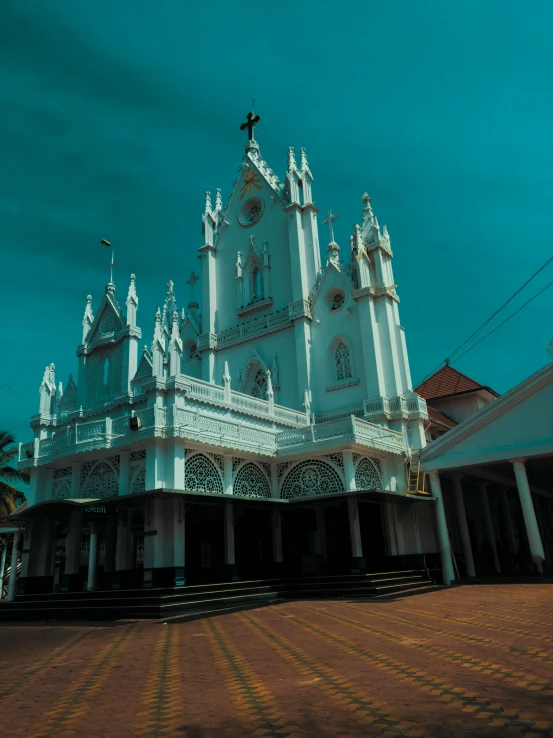 a large white building with tall towers and elaborate clocks