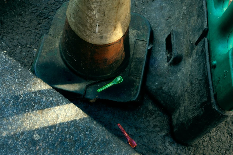 a traffic light laying on the ground next to a plastic bag