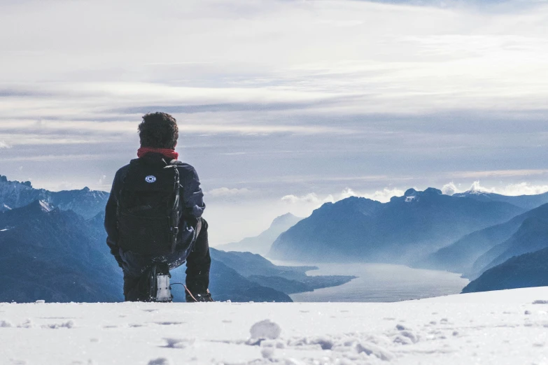 a person standing on top of a snow covered hill