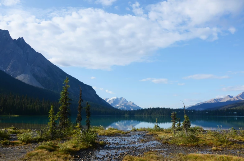 a water way between two mountains with trees around it