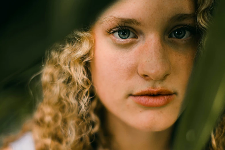 the close up portrait of a woman with curly hair