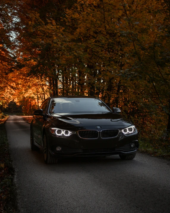 a black car that is on a small road