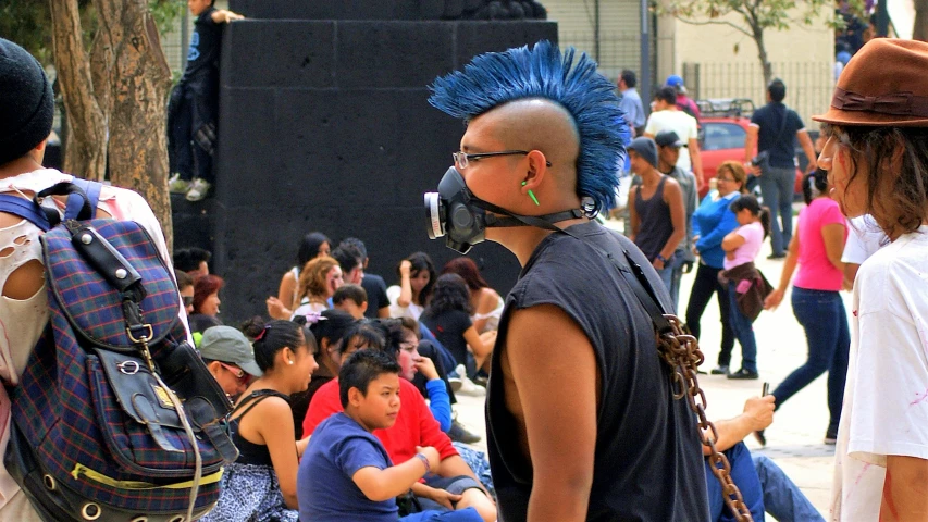 a group of people sit around a stage with microphones