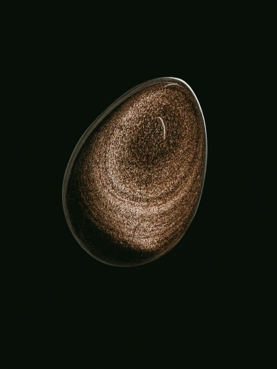 an oval object with black background, a very dark spot