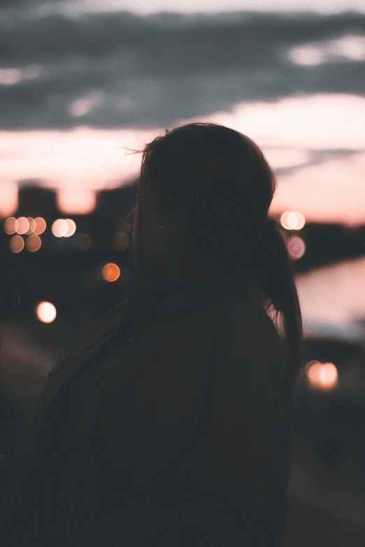 back view of a woman on the street at dusk