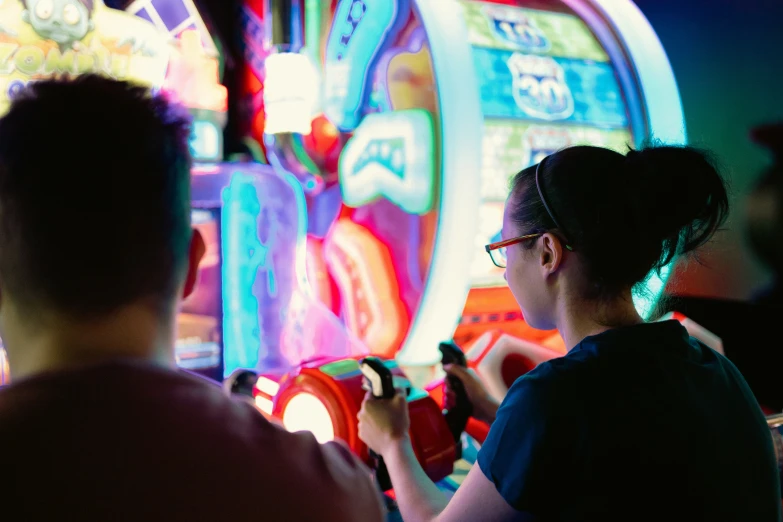 people playing with video game controllers in dark room