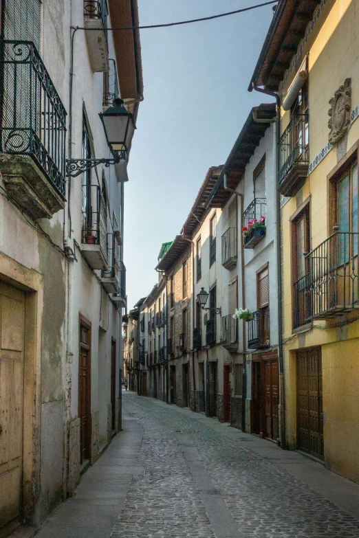 the back streets of the historic town with stone paved sidewalks and balconies