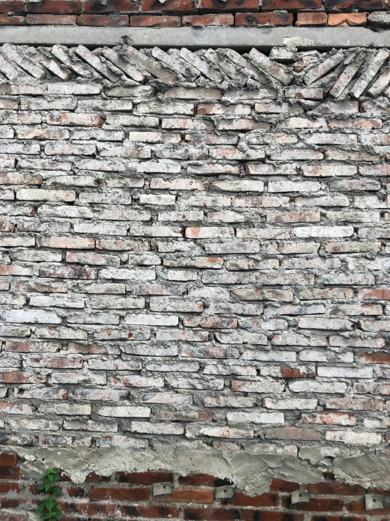 an old brick wall with a sign for the corner