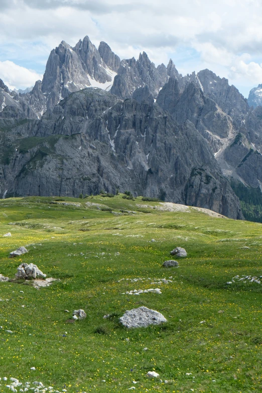 the mountains are covered in grass and rock