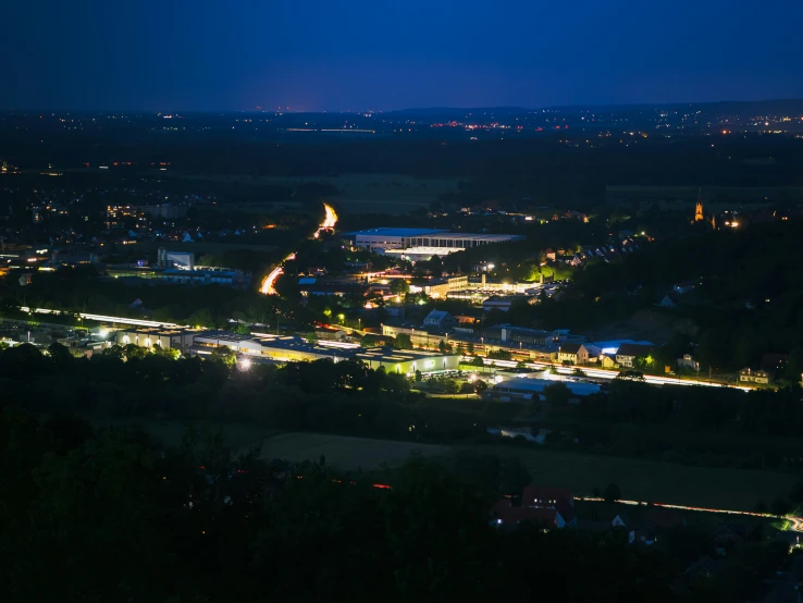 night skyline over town area illuminated with street lights