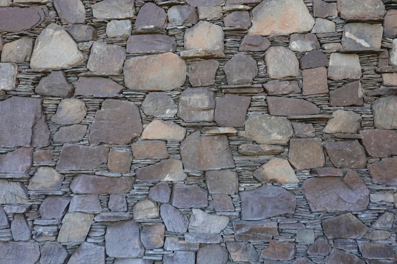 a stone wall made up of different sized stones
