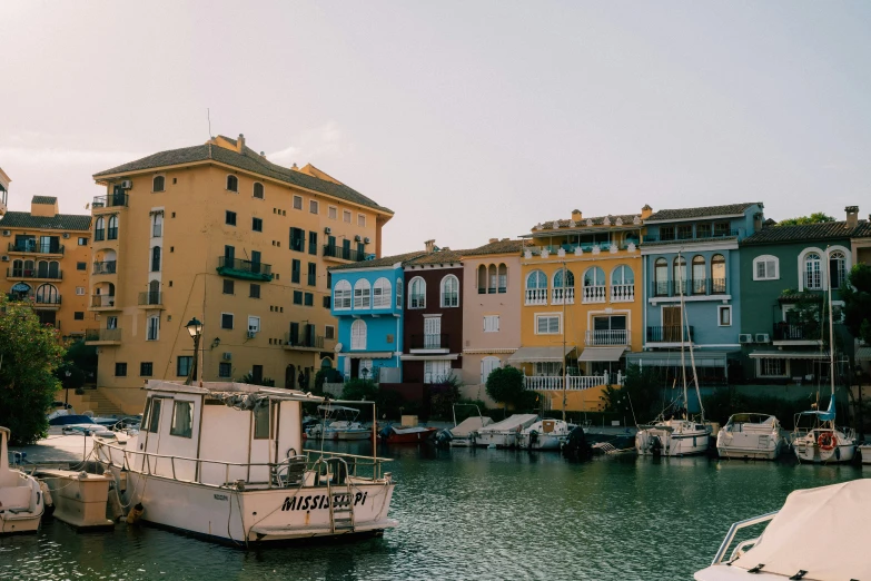 some boats sitting in the water and some buildings