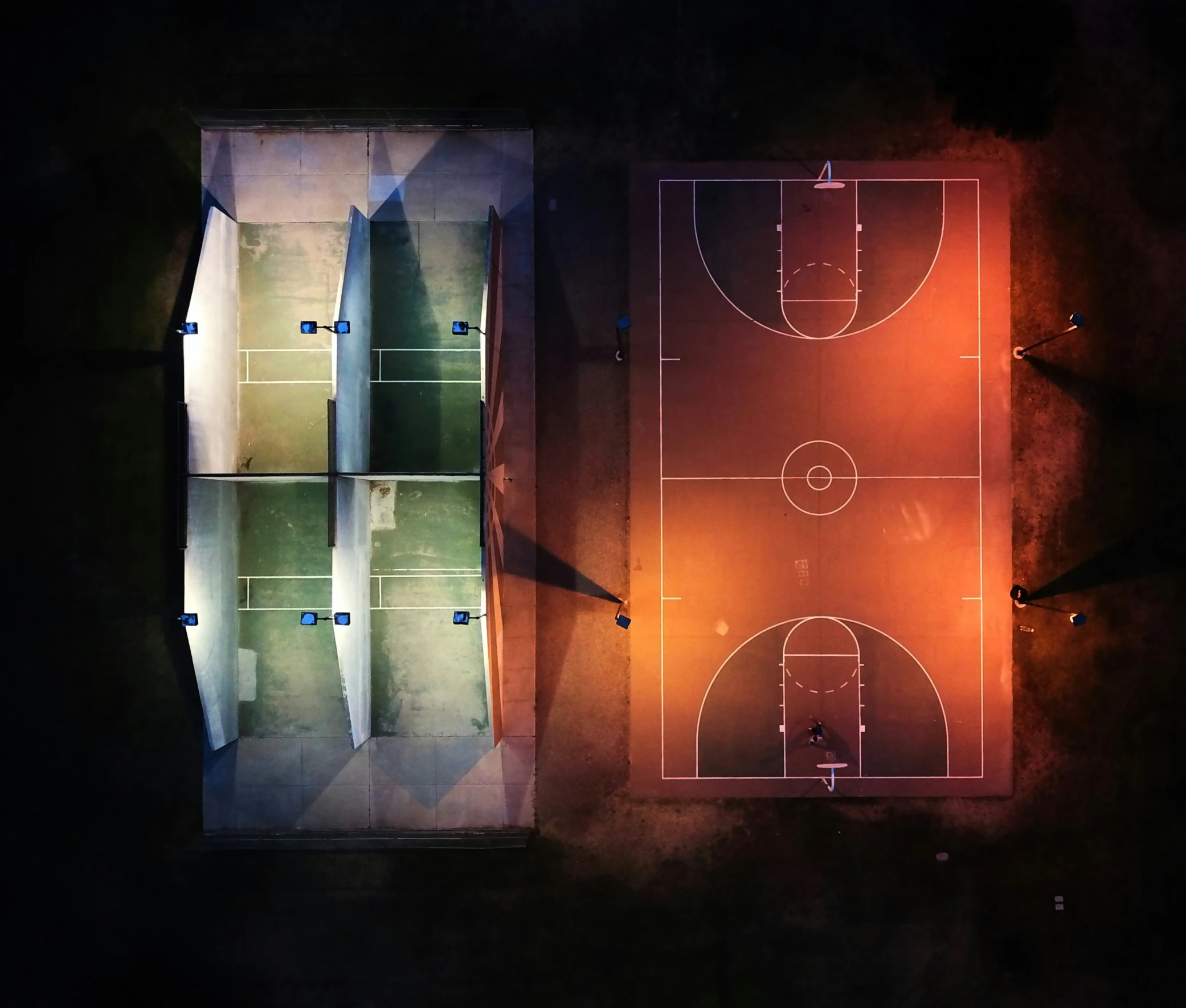 a basketball court with lights in the middle of it