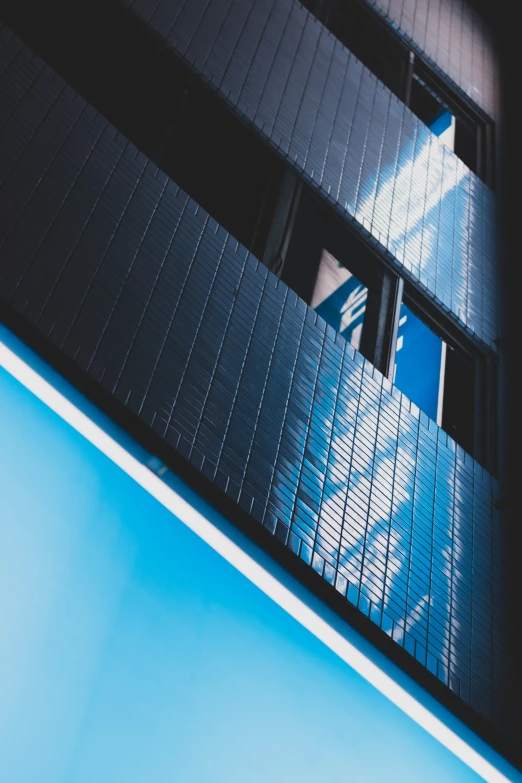 a building is being reflected in the window of another building